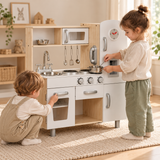 White wooden children’s toy kitchen with microwave, fridge and natural pine legs