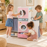 Three children playing with a pink wooden laundry playset with toy washing machine, sink and clothes rail