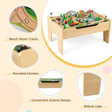 Wooden train activity table with the tabletop removed to reveal under-top toy storage.