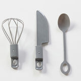 A knife, spoon and whisk is included on this Little Helper Montessori Wooden Toy Kitchen