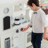 The knobs on the cooker rotate a full 360 degrees on this retro designed wooden toy kitchen