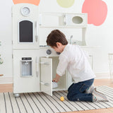 This wooden toy kitchen has a microwave, storage, clock, oven and water dispenser
